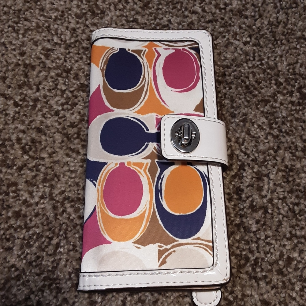 A Coach credit card and cash carrier